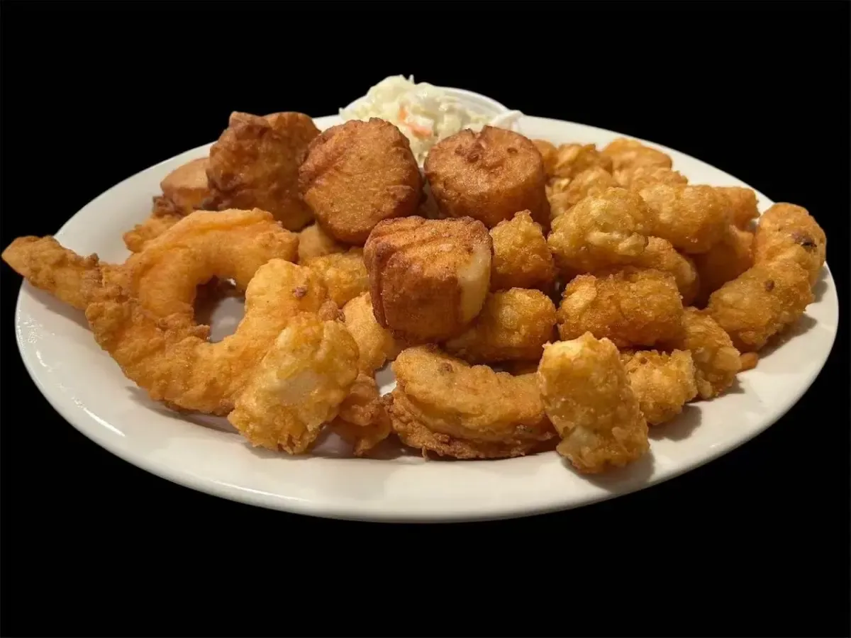 Platter of fried seafood and onion rings with coleslaw