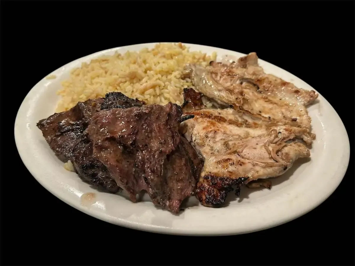 Grilled steak tips and chicken over rice
