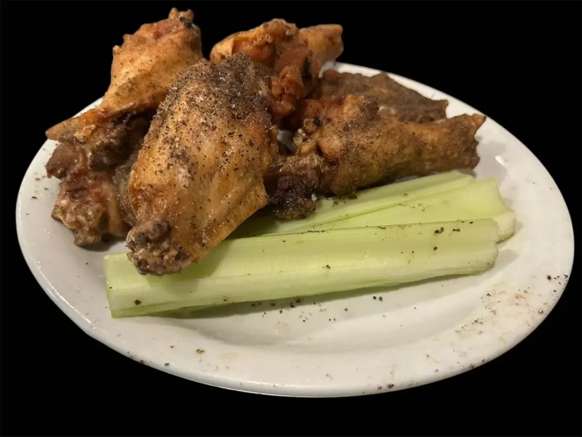 Seasoned chicken wings with celery sticks