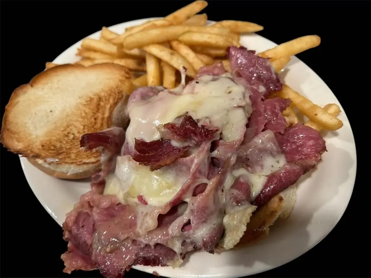 Hot pastrami sandwich with melted cheese and french fries
