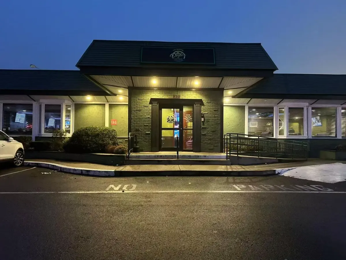 The Original Tommy Doyle's storefront at dusk with the entrance lit up
