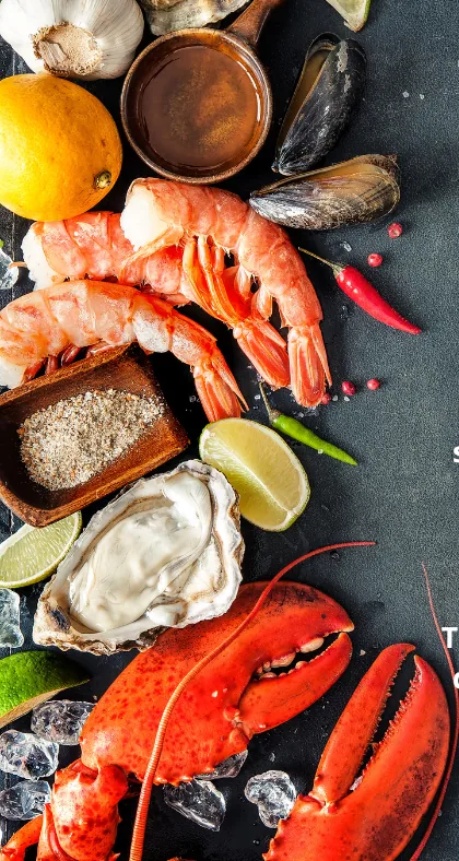 Shrimp, oysters, mussels, lemon and lobster claws laid out fresh